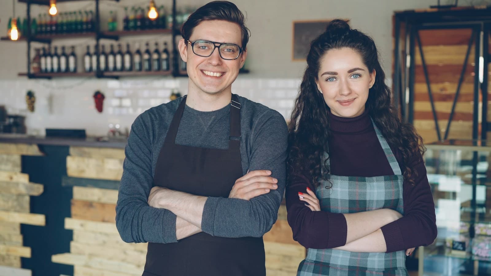 Two cafe owners standing together in their shop