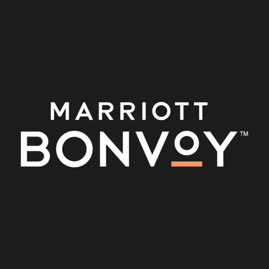 Marriott Bonvoy logo with white text on a black background and an orange underline beneath the O.