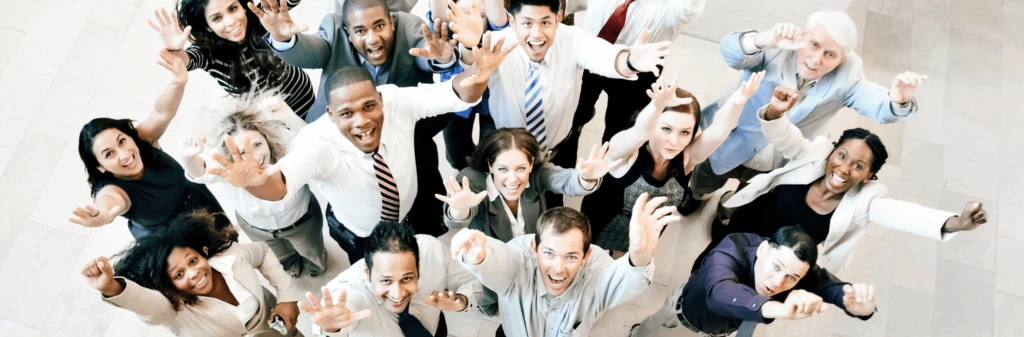 Diverse group of employees celebrating successful adoption of sustainable travel practices in the workplace.