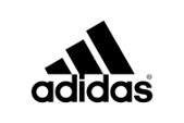A steaming cup of coffee on a saucer with a spoon, viewed from the side.